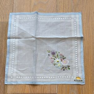 Vintage cotton handkerchief with a blue border and delicate floral embroidery